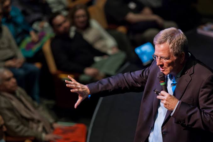 Rick Steves performing live on stage